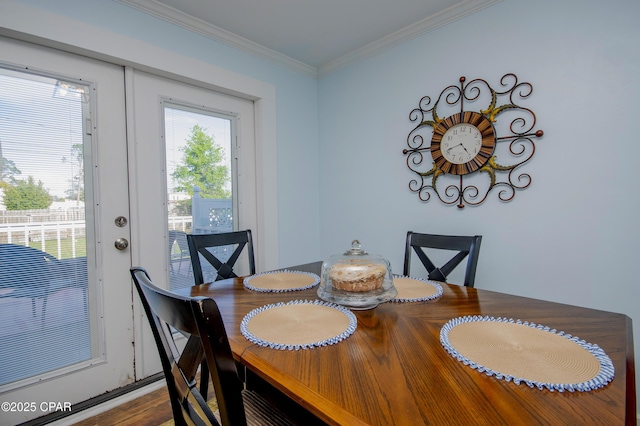 dining area with ornamental molding and wood finished floors