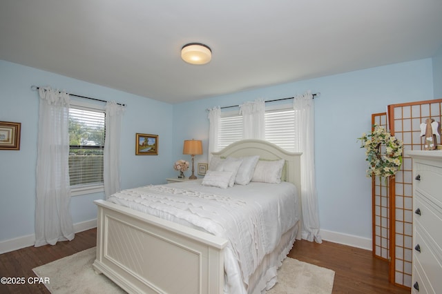 bedroom featuring wood finished floors and baseboards
