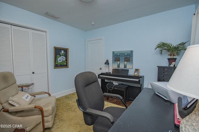 carpeted home office featuring baseboards and visible vents