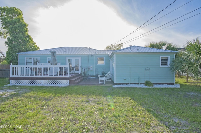 106 N Cove Blvd, Panama City, FL 32401 - back of house with a deck, french doors, a lawn, and metal roof