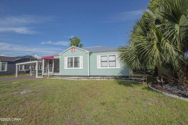 106 N Cove Blvd, Panama City, FL 32401 - view of front of property with a front lawn, metal roof, and a carport