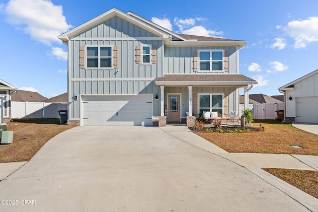 craftsman-style home featuring fence, an attached garage, board and batten siding, a porch, and driveway