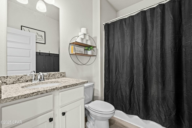 full bath with a shower with shower curtain, toilet, wood finished floors, and vanity
