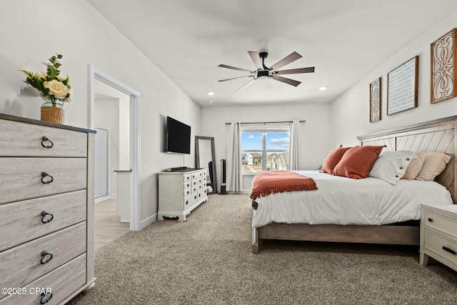 bedroom with baseboards, a ceiling fan, and light colored carpet