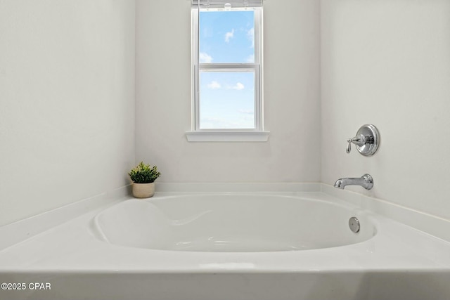 bathroom featuring plenty of natural light and a garden tub