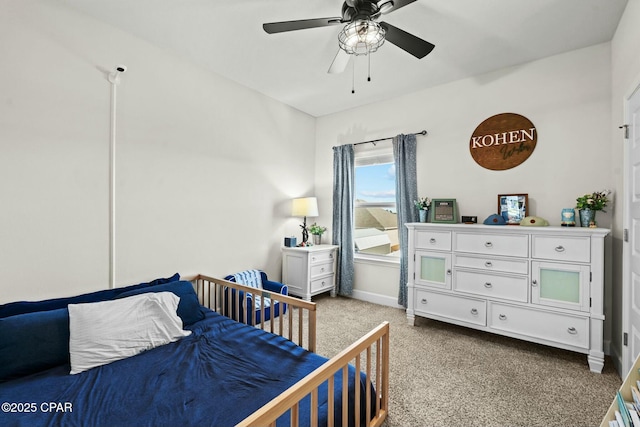 carpeted bedroom with baseboards and ceiling fan
