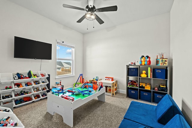 recreation room featuring carpet floors, baseboards, and ceiling fan