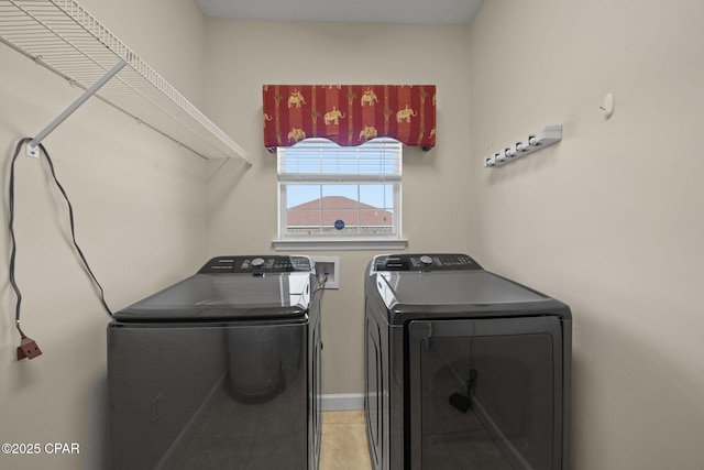 laundry area with light tile patterned floors, independent washer and dryer, and laundry area