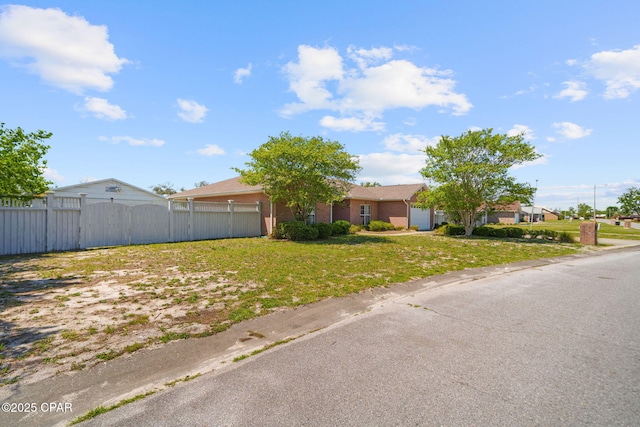 ranch-style house with fence and an attached garage