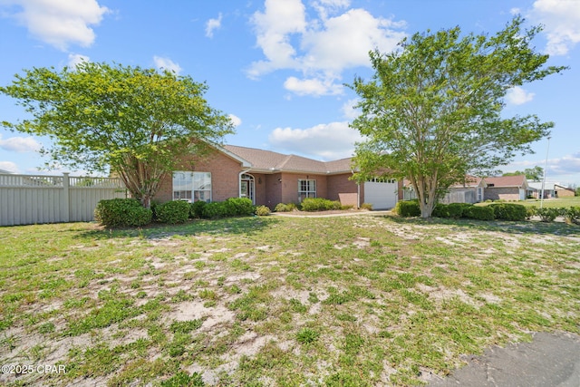 single story home with brick siding, a front lawn, fence, and an attached garage