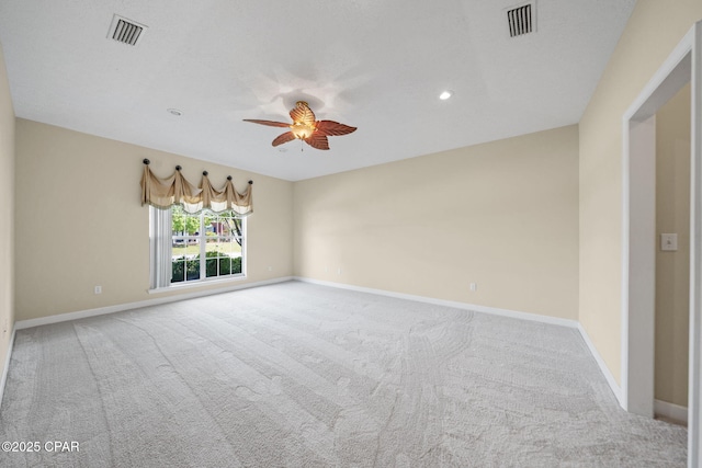 carpeted empty room featuring visible vents, ceiling fan, recessed lighting, and baseboards