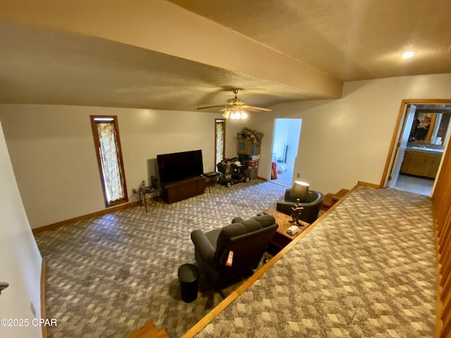 carpeted living area featuring baseboards and ceiling fan