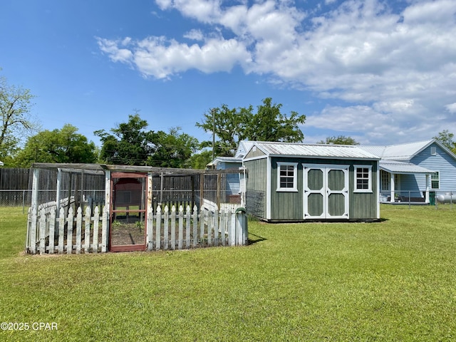 view of shed featuring fence and exterior structure