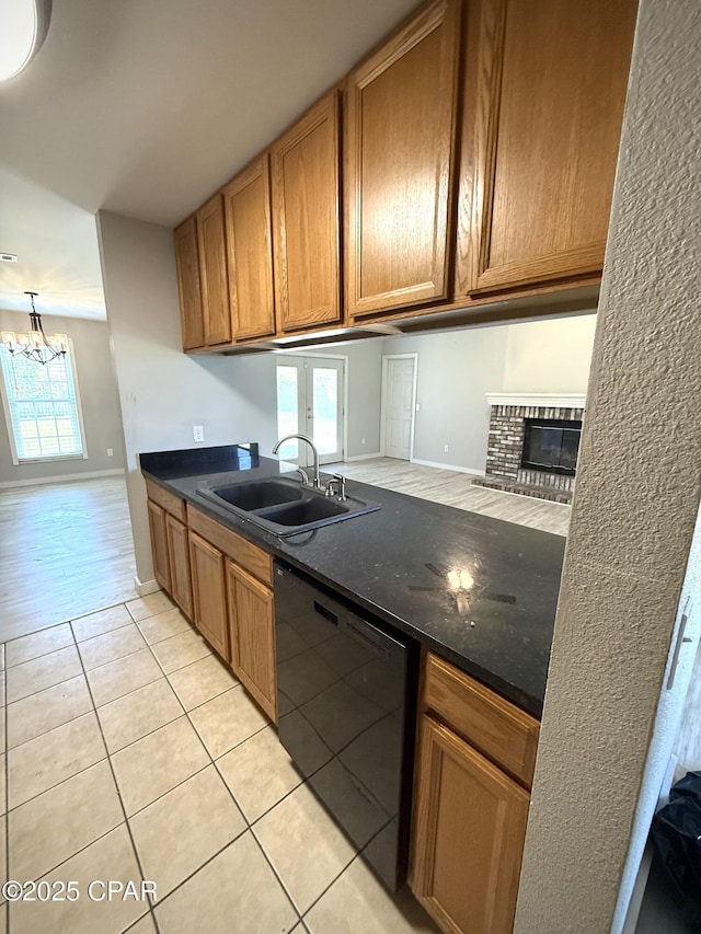 1421 S Berthe Ave, Panama City, FL 32404 - kitchen featuring light tile patterned flooring, a notable chandelier, a sink, dishwasher, and brown cabinetry