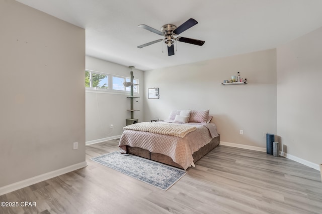 bedroom featuring baseboards, a ceiling fan, and wood finished floors