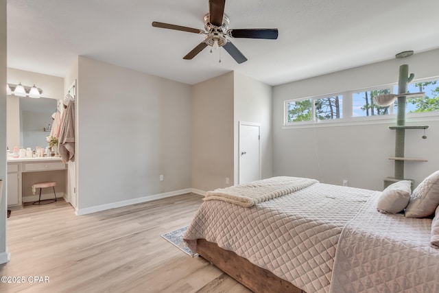 bedroom featuring light wood-type flooring, ensuite bathroom, baseboards, and ceiling fan