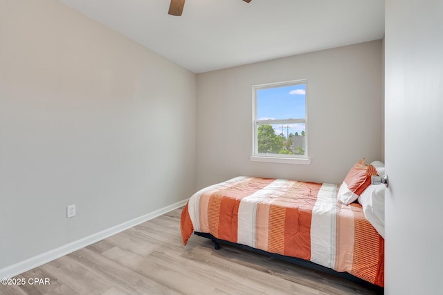 bedroom featuring baseboards, a ceiling fan, and wood finished floors