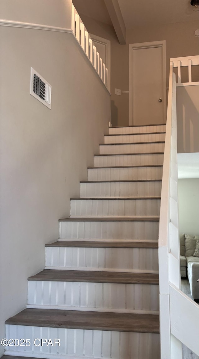 stairs with beamed ceiling and visible vents