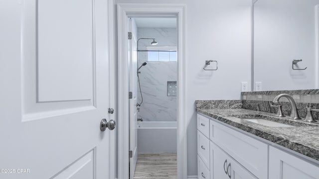 bathroom featuring shower / washtub combination and vanity