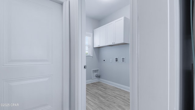 laundry area with cabinet space, light wood-type flooring, electric dryer hookup, hookup for a washing machine, and baseboards