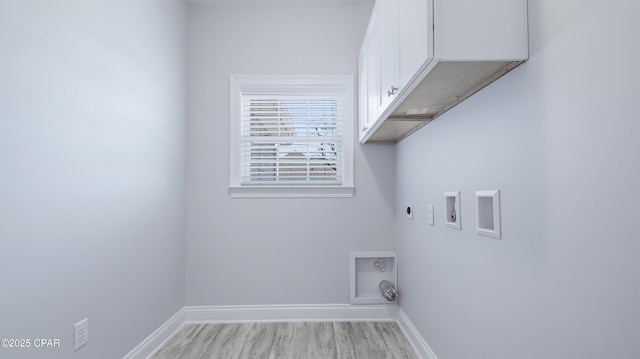 laundry room with electric dryer hookup, baseboards, cabinet space, and washer hookup