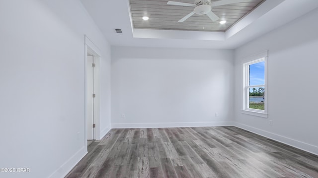 1113 New Hampshire Ave, Lynn Haven, FL 32444 - spare room with a raised ceiling, ceiling fan, visible vents, baseboards, and wood finished floors