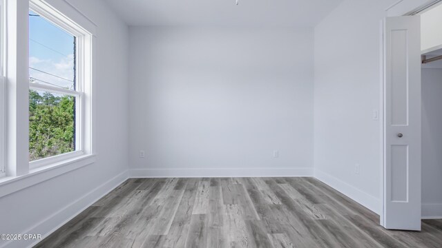 1113 New Hampshire Ave, Lynn Haven, FL 32444 - empty room with wood finished floors and baseboards