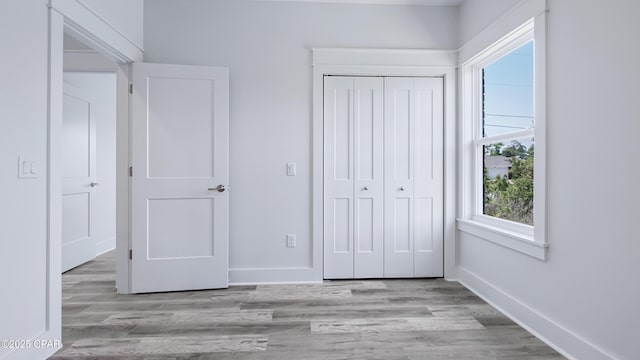 1113 New Hampshire Ave, Lynn Haven, FL 32444 - unfurnished bedroom with wood finished floors, baseboards, and a closet