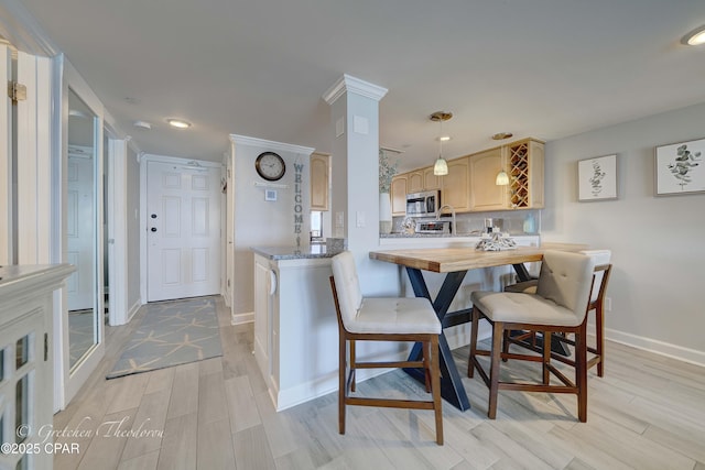 dining room featuring recessed lighting, baseboards, and light wood-type flooring