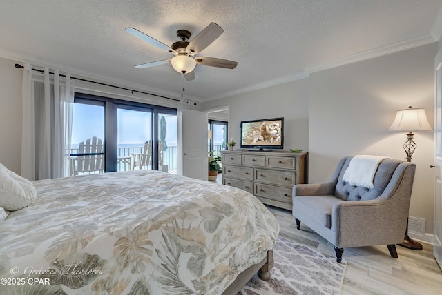 bedroom with crown molding, access to outside, multiple windows, and light wood-type flooring