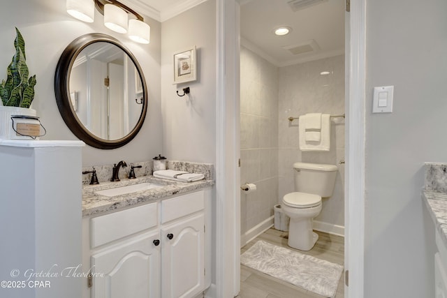 bathroom featuring tile patterned flooring, visible vents, toilet, vanity, and ornamental molding
