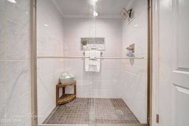 bathroom with a shower stall and crown molding