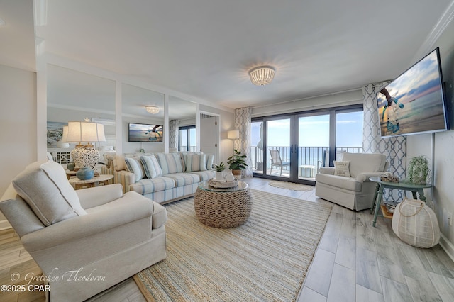 living room with light wood finished floors, french doors, and a wealth of natural light