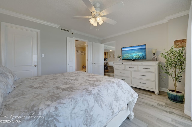 bedroom featuring ceiling fan, light wood-style flooring, baseboards, and ornamental molding