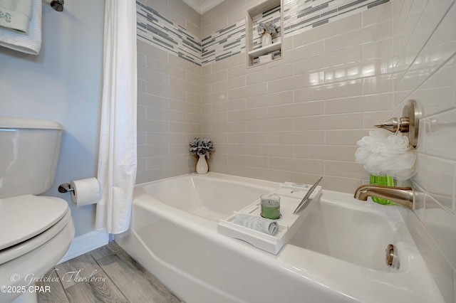 bathroom featuring shower / bath combination with curtain, toilet, wood finished floors, and baseboards