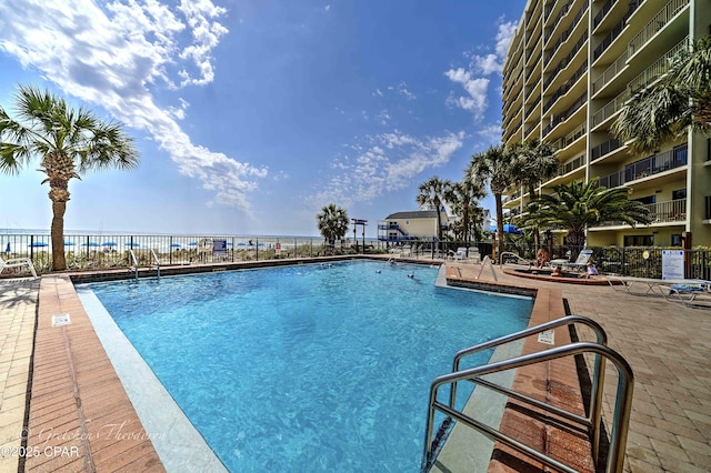 pool featuring a patio and fence