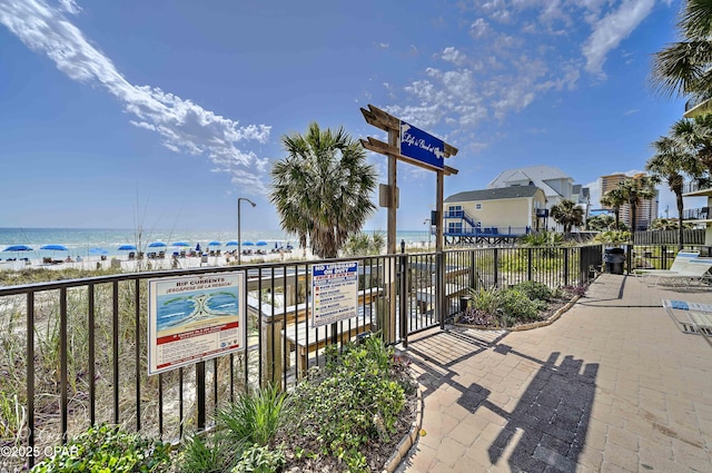 view of home's community with fence and a water view