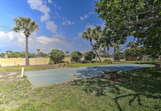 exterior space with a lawn and fence