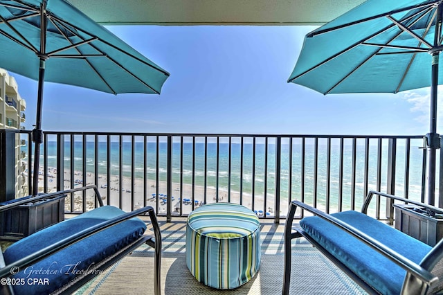 balcony with a view of the beach and a water view