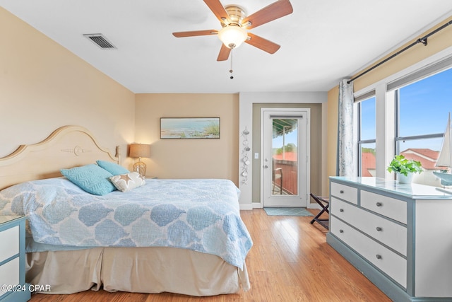 8730 Thomas Dr Unit 1311C, Panama City Beach, FL 32408 - bedroom featuring access to exterior, light wood-type flooring, and a ceiling fan