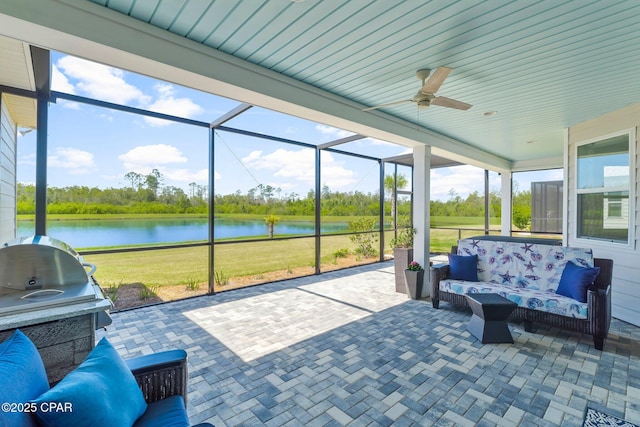 sunroom / solarium featuring a water view, outdoor lounge area, and ceiling fan