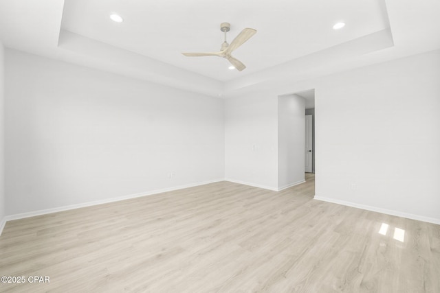 spare room with light wood-type flooring, baseboards, a ceiling fan, and recessed lighting