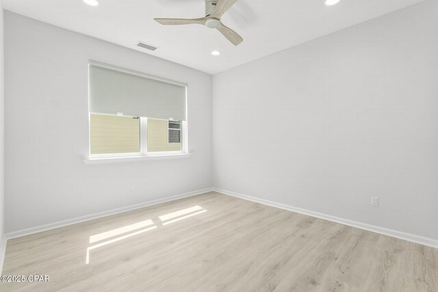 spare room with baseboards, recessed lighting, and wood finished floors