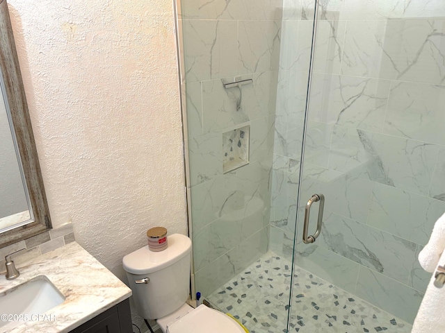 312 Sukoshi Dr, Panama City, FL 32404 - bathroom featuring a shower stall, toilet, a textured wall, and vanity