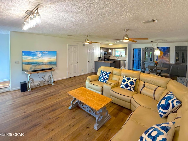 312 Sukoshi Dr, Panama City, FL 32404 - living area with ceiling fan, wood finished floors, a textured ceiling, and visible vents