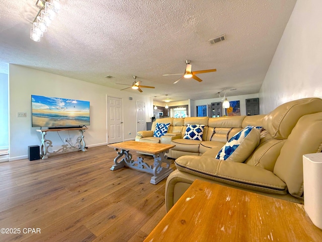 312 Sukoshi Dr, Panama City, FL 32404 - living area with a textured ceiling, baseboards, visible vents, ceiling fan, and wood-type flooring