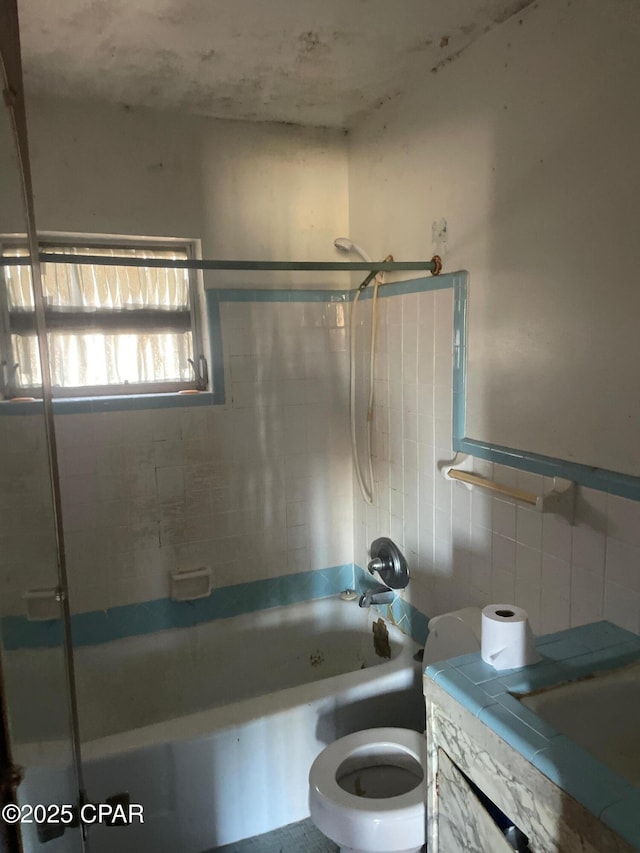 609 Bob Little Rd, Panama City, FL 32404 - full bath featuring vanity, tile walls, washtub / shower combination, and toilet