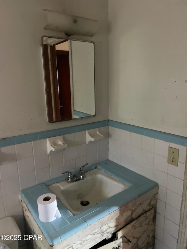 609 Bob Little Rd, Panama City, FL 32404 - half bath featuring toilet, tile walls, vanity, and wainscoting