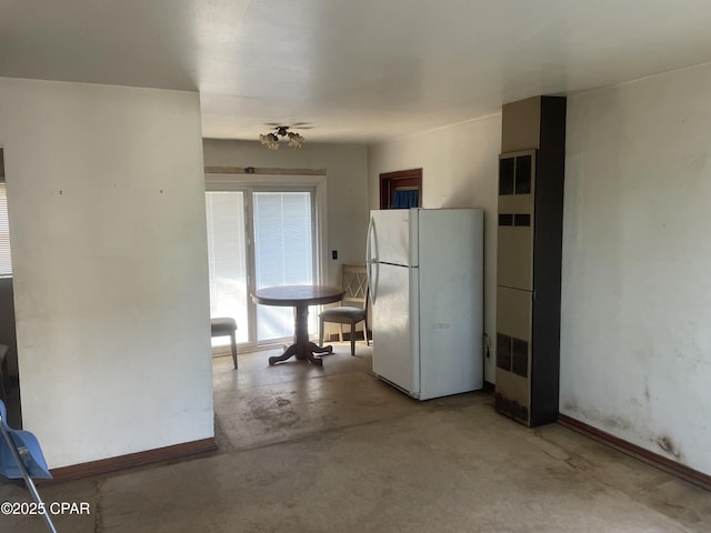 609 Bob Little Rd, Panama City, FL 32404 - kitchen featuring freestanding refrigerator, a heating unit, and concrete floors
