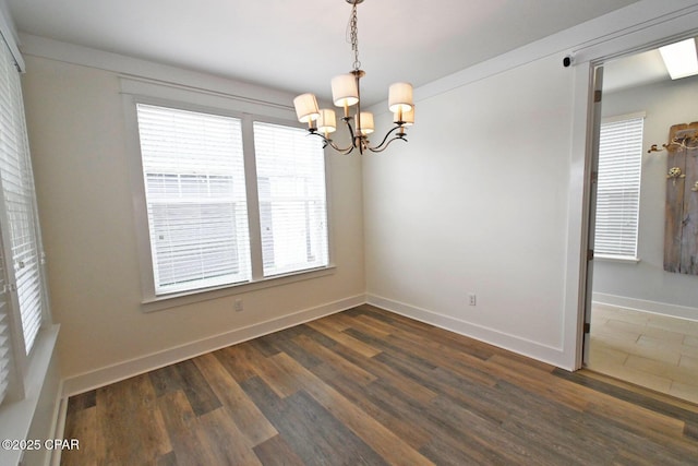 3116 Veranda Ave, Panama City, FL 32405 - unfurnished room featuring a chandelier, dark wood-type flooring, and baseboards